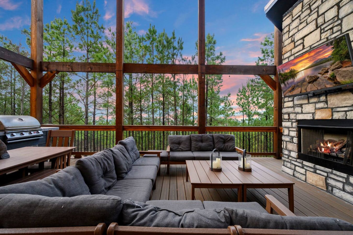 This deck is basically every outdoor living dream with a fireplace, grill, and those forest views that just go on forever.