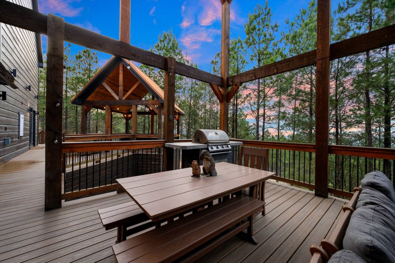 This sprawling deck has everything you need to hang out all day with views through the pines.