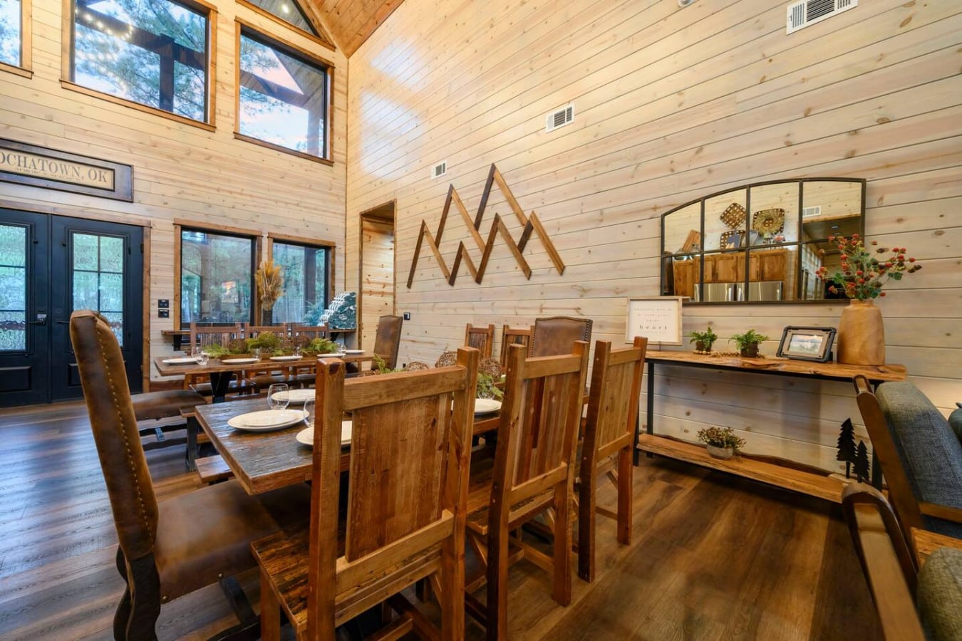 This soaring timber-framed dining hall floods with natural light and mountain views, perfect for gathering.