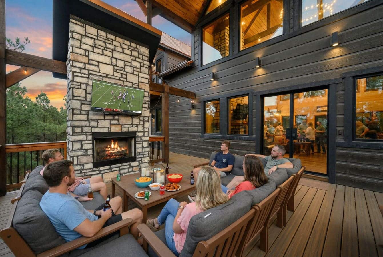 Gather around the outdoor fireplace on the expansive deck with stunning forest views and cozy seating for the whole crew.