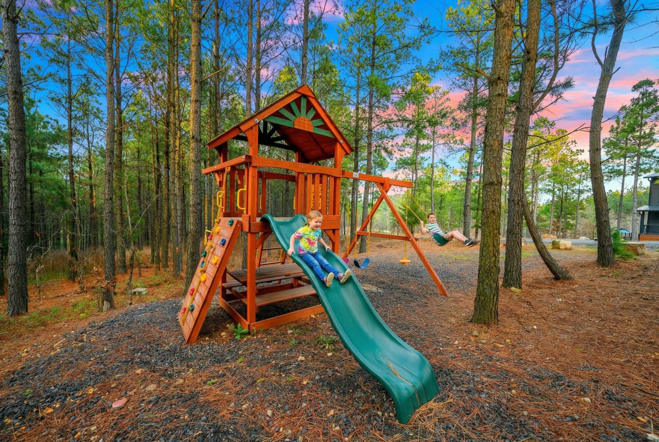 Kids will have a blast on this awesome wooden playset tucked into the peaceful pine forest.