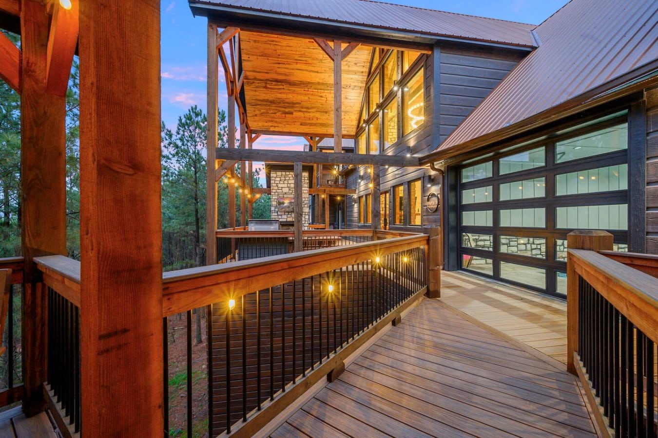 This expansive wrapped deck with ambient lighting is basically your own private resort overlooking the forest.