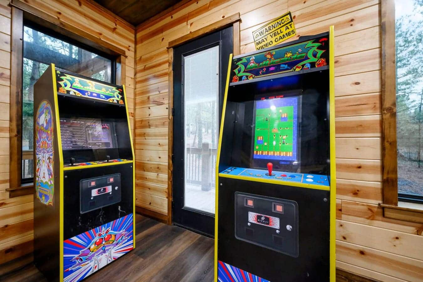 Two classic arcade games are ready to bring out your competitive side in this cozy cabin game room.
