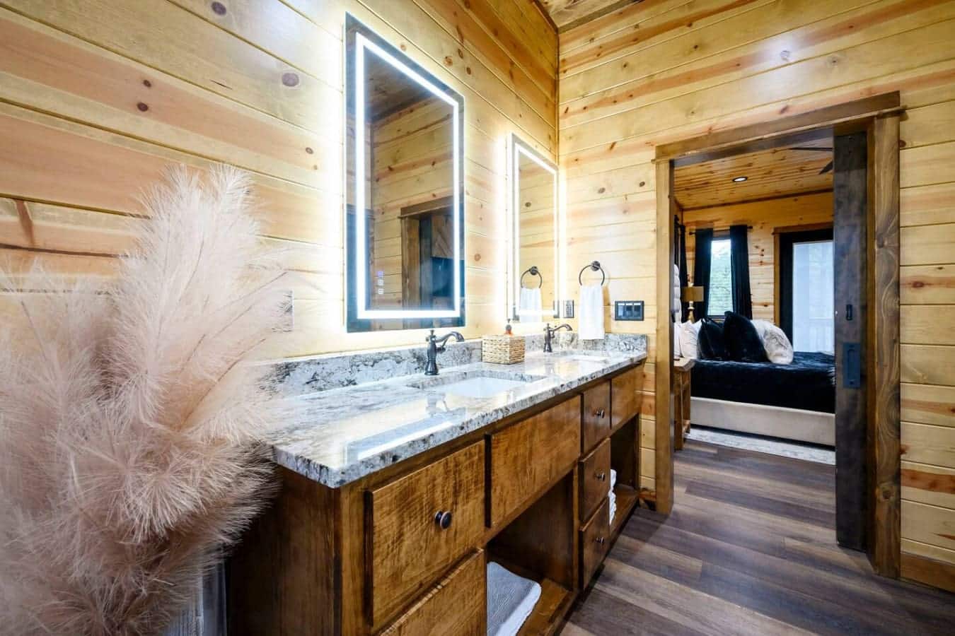 This spa-like master bath features dual vanities, heated mirrors, and gorgeous marble countertops throughout the cabin.