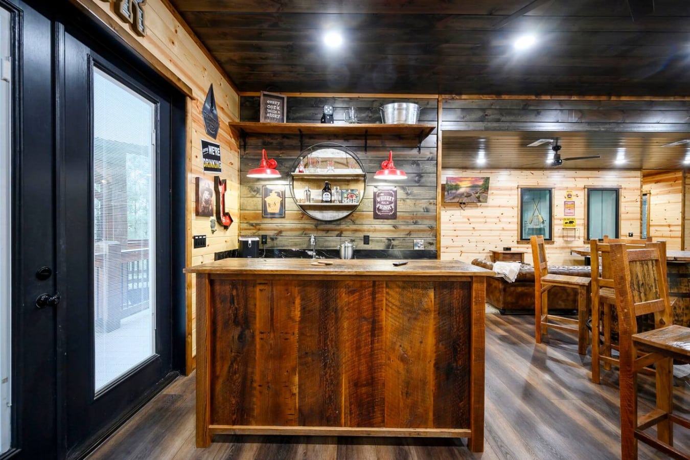 This rustic cabin bar is the perfect spot to gather with friends and enjoy the cozy wood-lined interior.