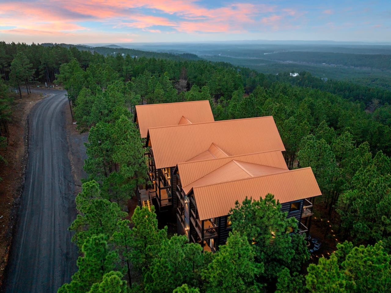 This stunning hilltop lodge sits nestled in the pines with breathtaking valley views for miles.