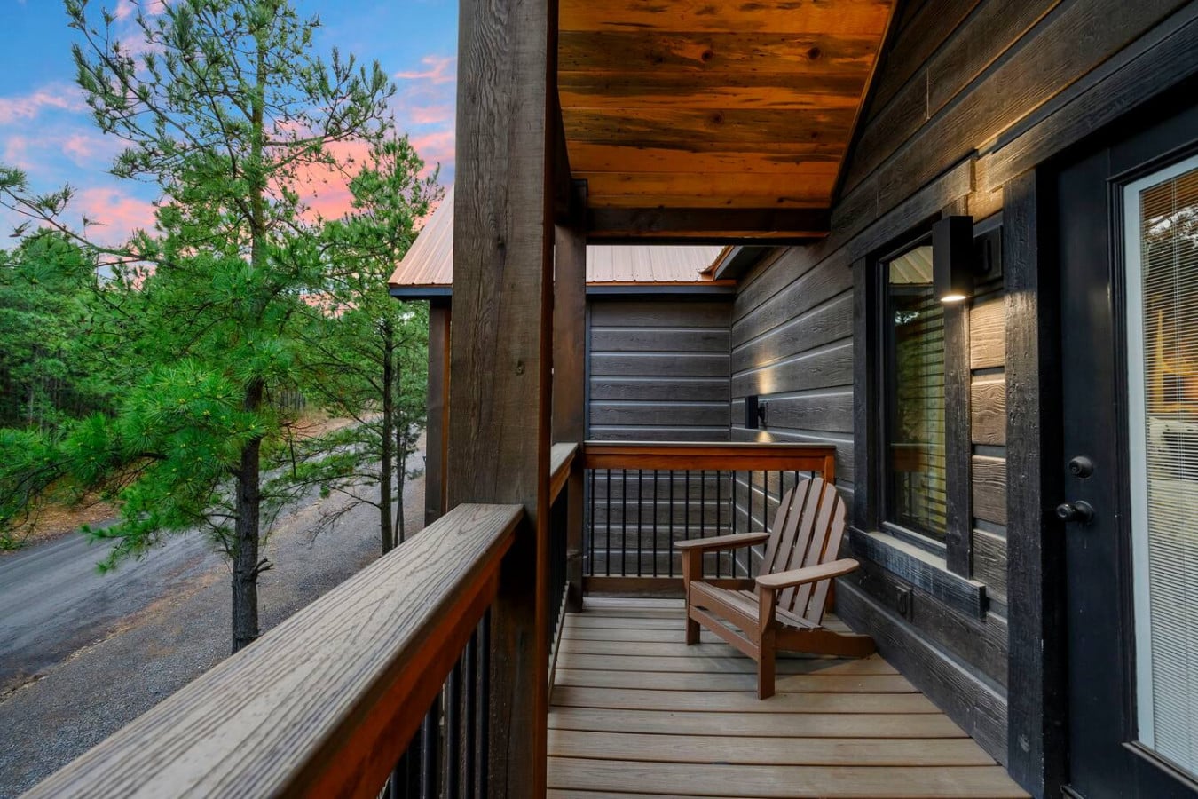 Wake up on this covered deck with your morning coffee and watch the sunrise light up the pine forest.