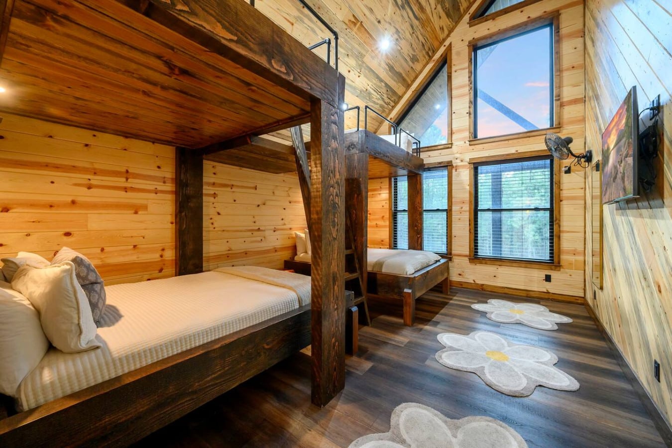 This gorgeous log cabin bedroom features soaring ceilings, a four-poster bed, and those mountain views through the skylights.