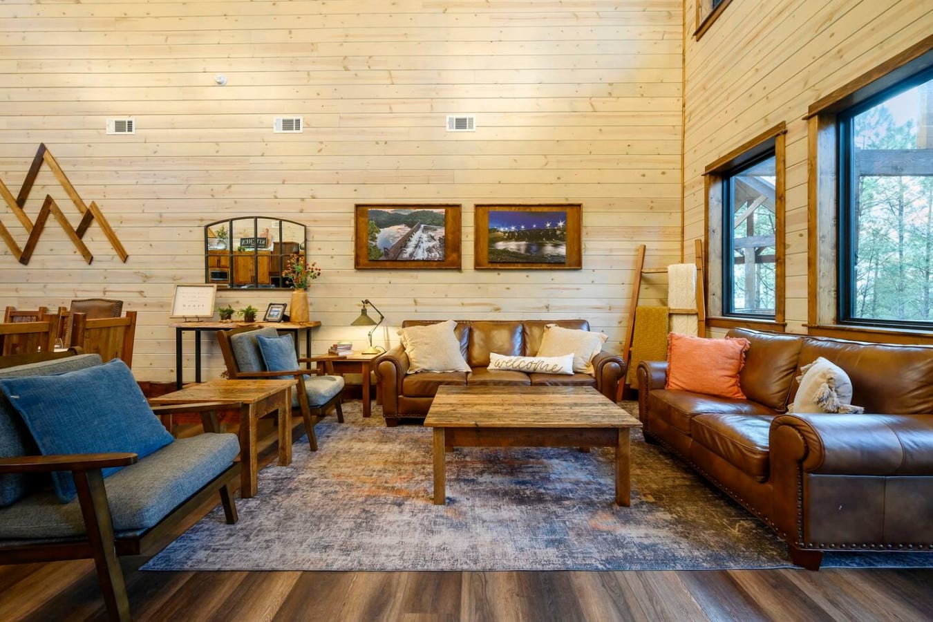 Cozy living room with leather seating, wood beams, and plenty of natural light from those huge windows.