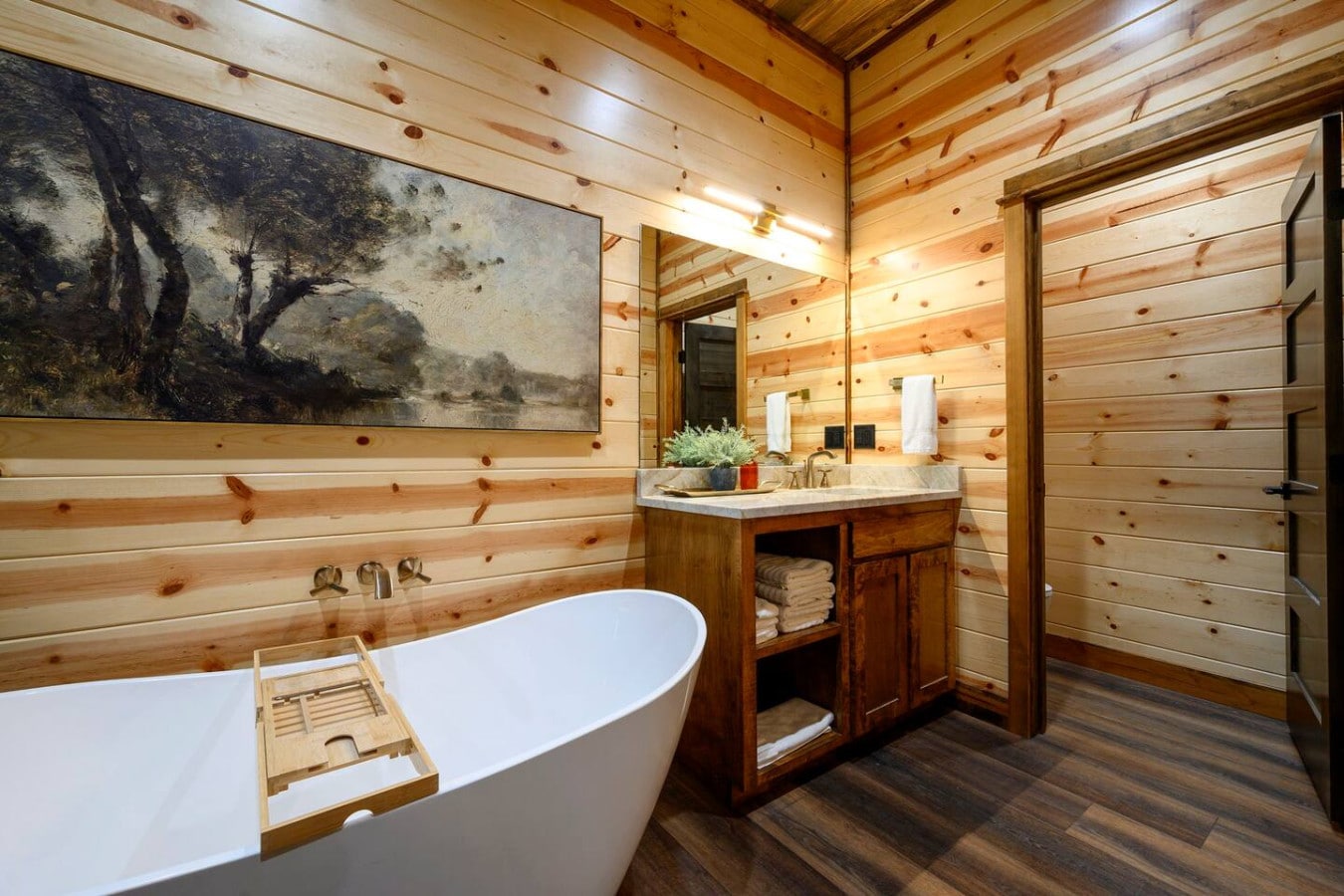Soaking in this wood-lined bathroom with a freestanding tub feels like a spa day in a cozy cabin.