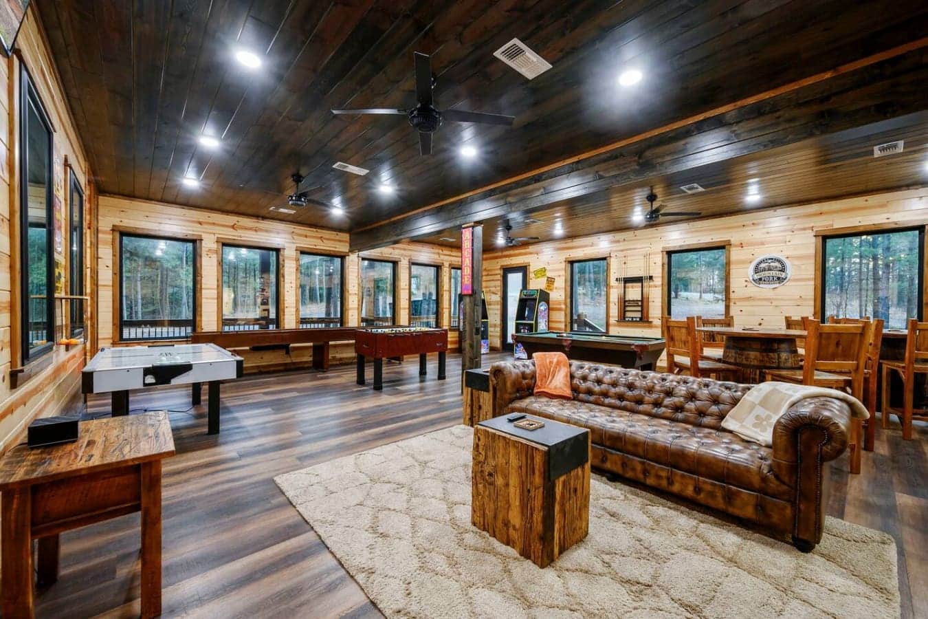 This massive game room has everything—pool table, air hockey, foosball, and windows overlooking the forest on every wall.