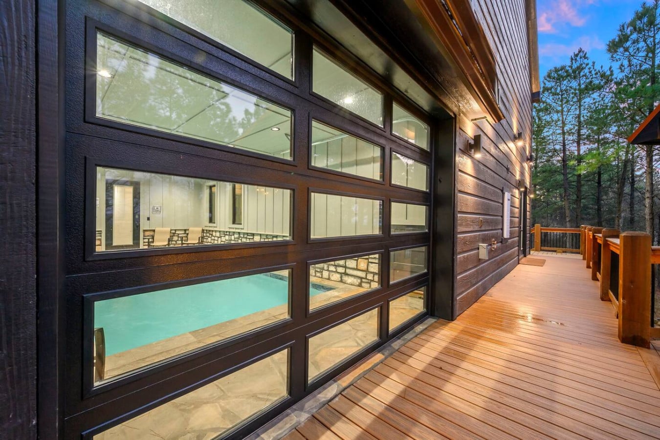 Floor-to-ceiling windows showcase an indoor pool right from your private deck overlooking the forest.