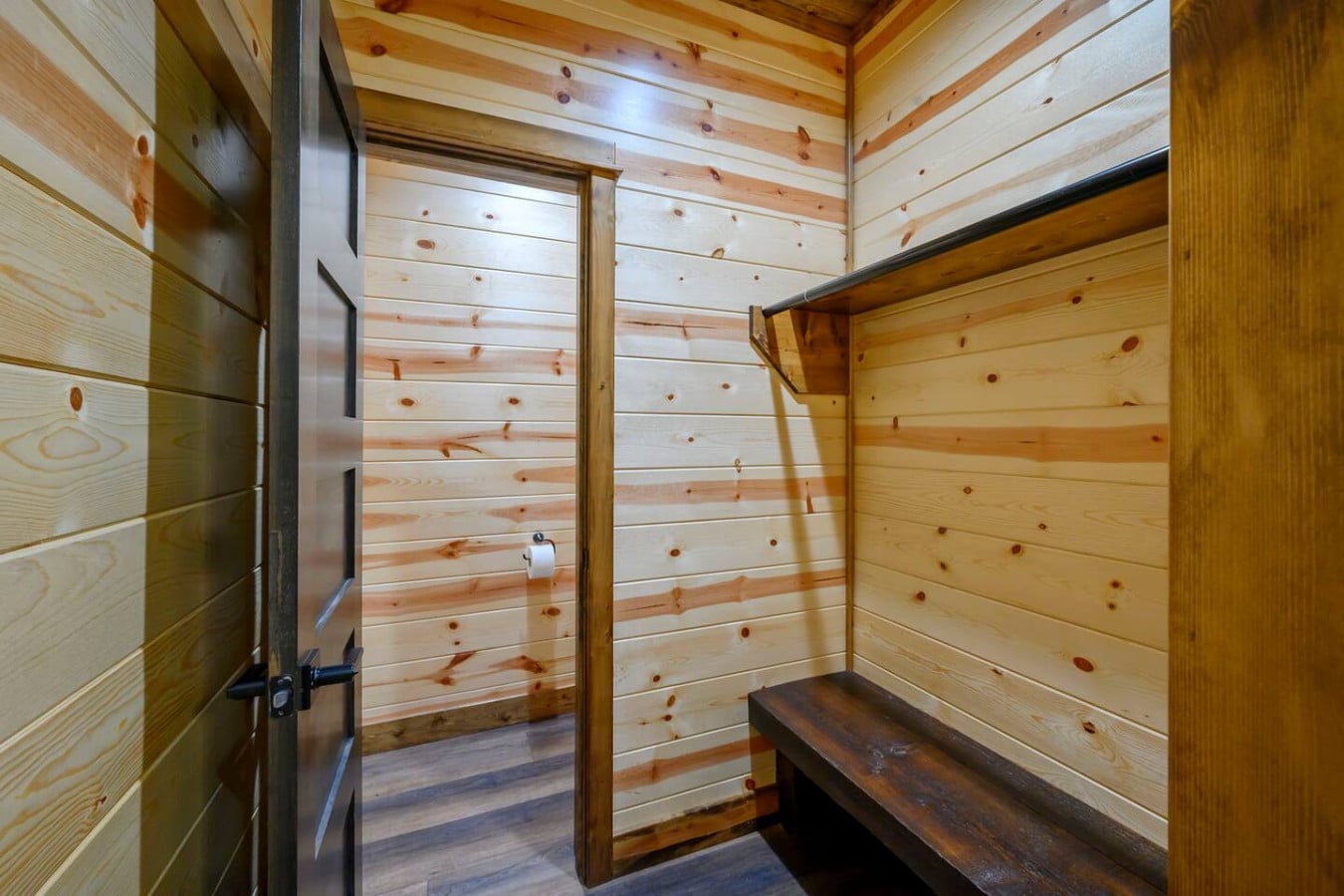 This cozy log sauna features beautiful wood construction and a rustic bench perfect for relaxing.
