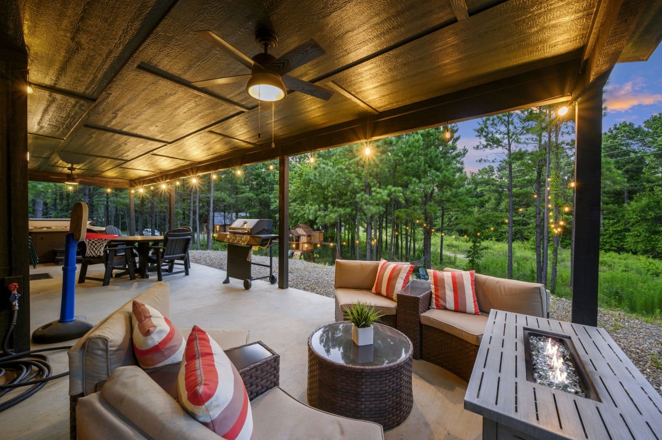 Spacious outdoor lounge arranged for relaxing under the covered deck.