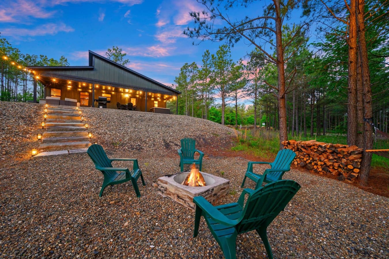 As twilight rolls in and those teal Adirondack chairs gather around a crackling fire pit, your modern cabin glows like a beacon tucked back in the pines—pretty much the definition of a perfect forest escape.