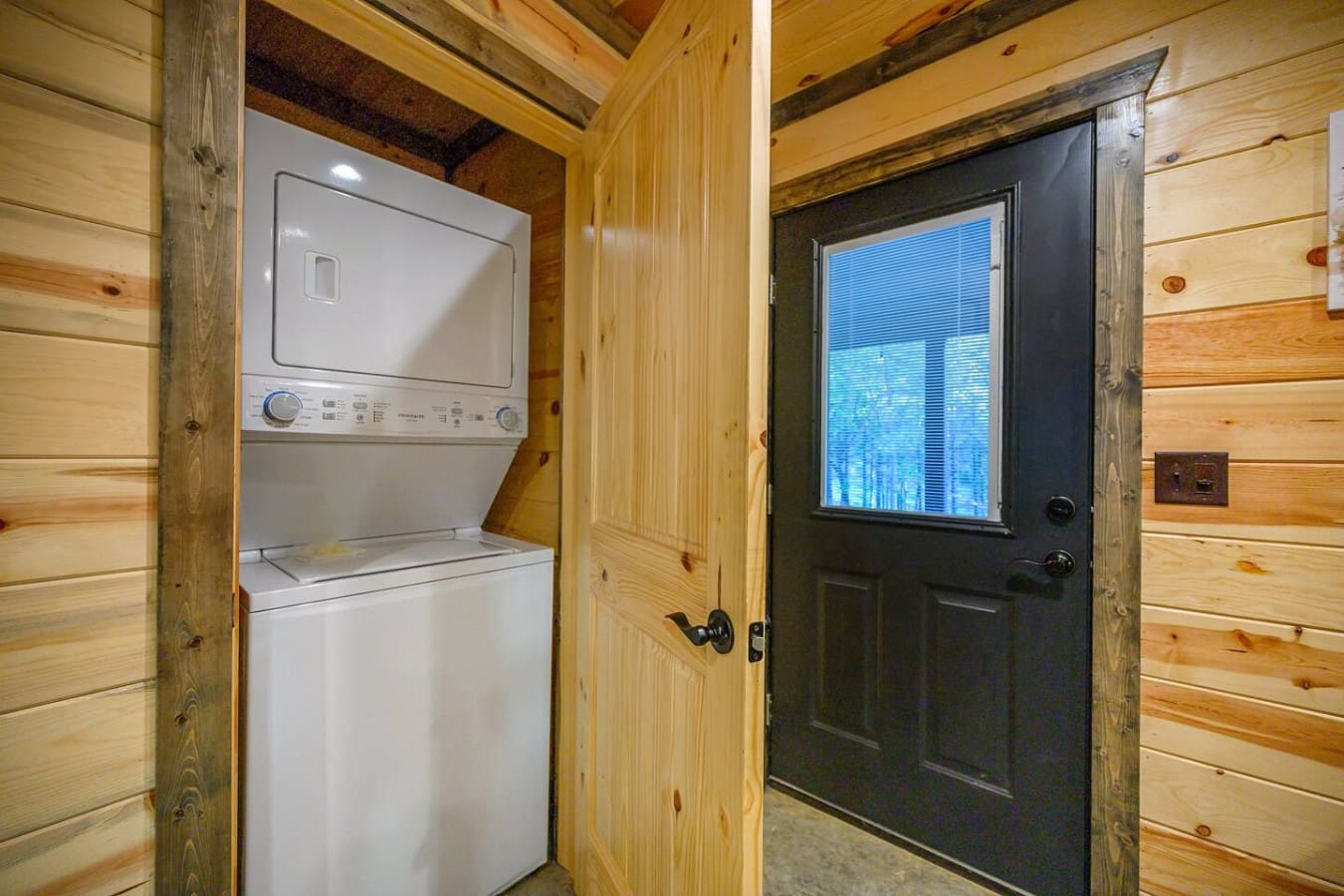 This laundry nook tucked into the cabin is a total game-changer for longer stays—stackable washer and dryer combo means you can actually pack lighter and still stay fresh the whole trip.