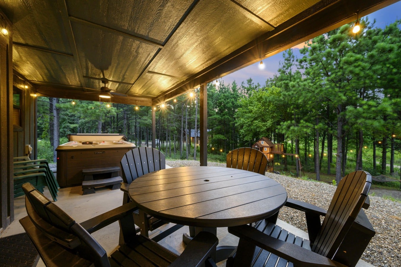 Covered patio dining area with grill nearby for cookouts at the cabin.