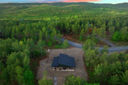 Imagine having your own modern cabin completely tucked away in the middle of endless pine forest with a river winding through the trees—this is basically what living off the grid actually looks like.