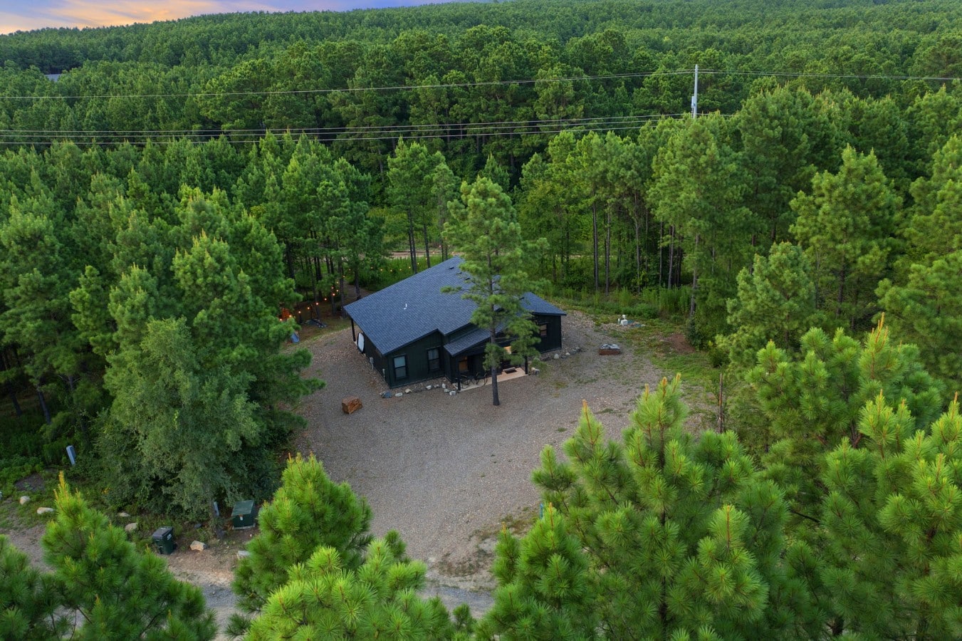 Wide aerial view of The Animal Crossing in its private wooded setting.