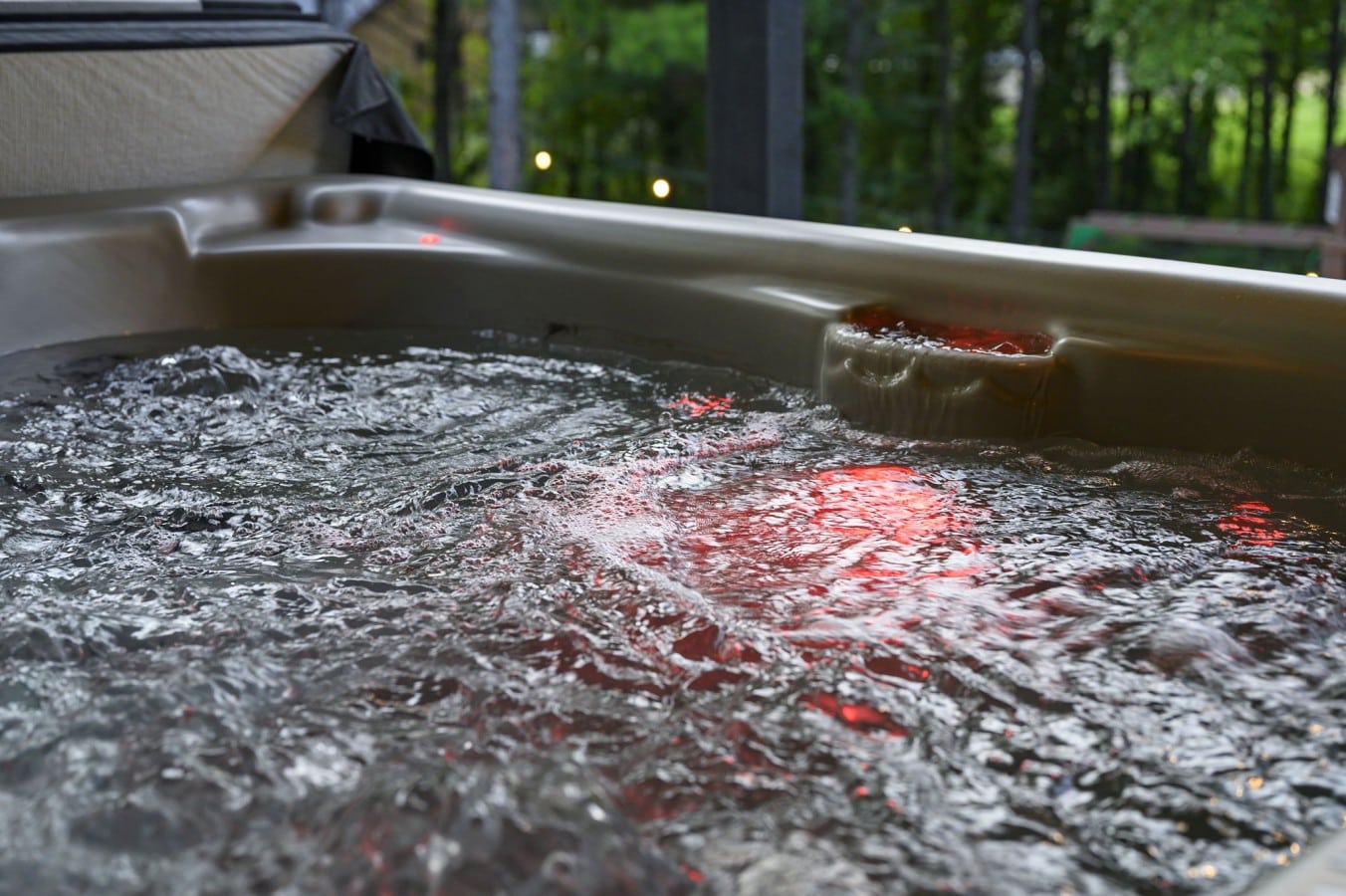 Bubbling hot tub close-up under the covered outdoor living area.