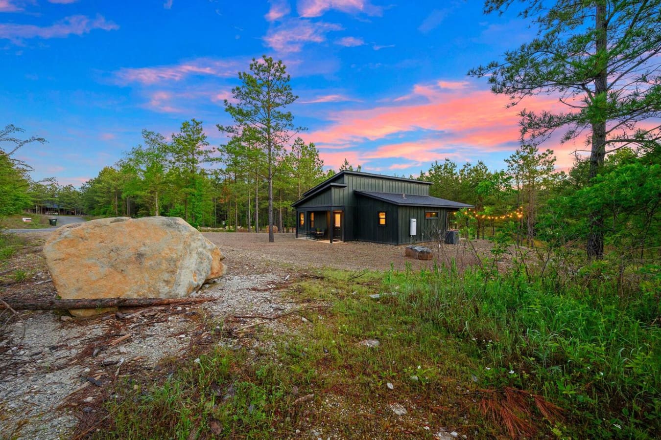 Watch this sleek modern cabin come alive as the sun sets, casting that perfect glow across the clearing while the forest stays still and quiet all around you.