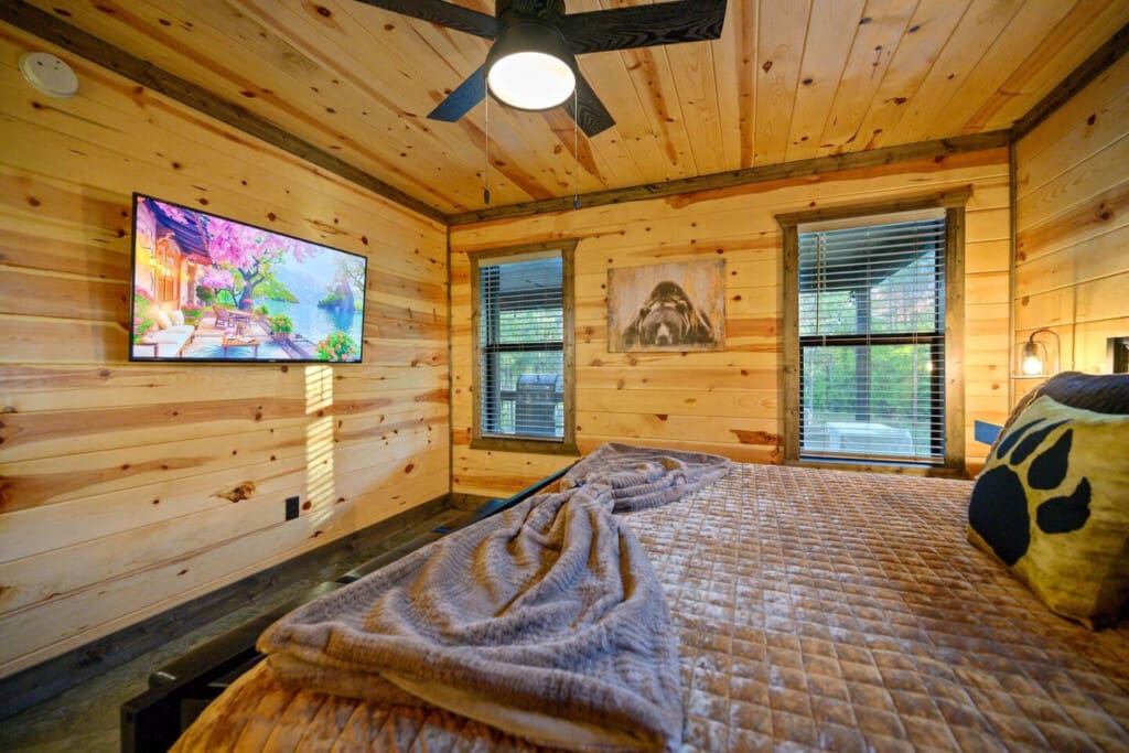 Wake up to a TV showing scenic views while the real forest does its thing outside your windows, because sometimes you want both entertainment and that genuine cabin immersion all at once.