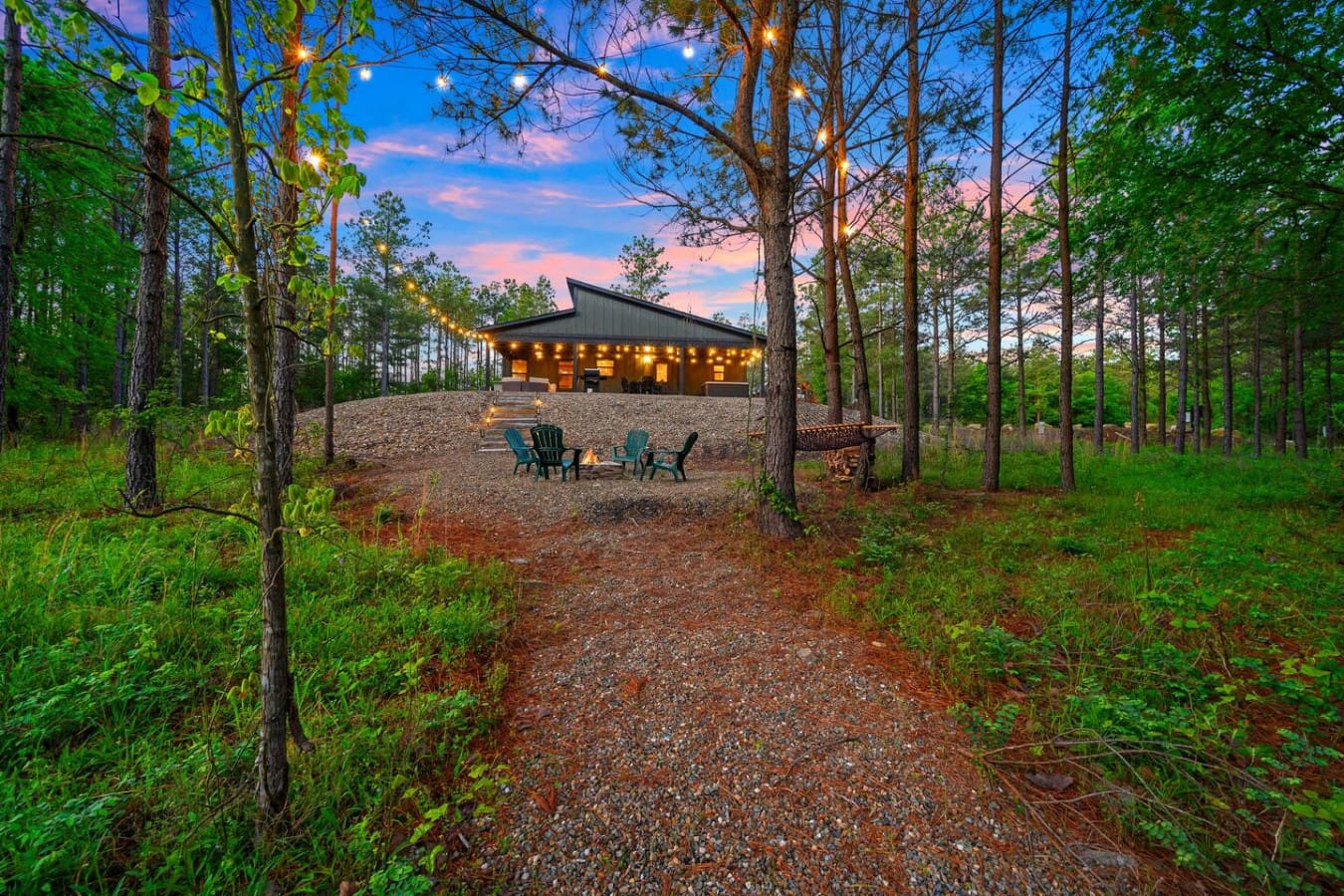 Nothing quite beats that moment when your modern cabin lights up against the twilight sky while you're gathered around the fire pit with nothing but towering pines and that gorgeous blue-pink sky surrounding you.