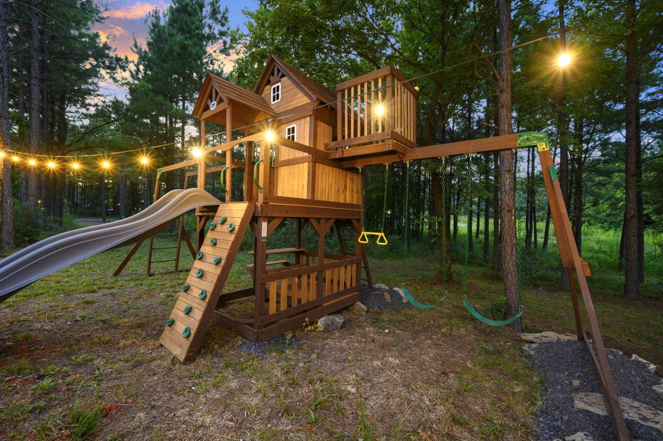 Playset close-up with slide, swings, and climbing features.