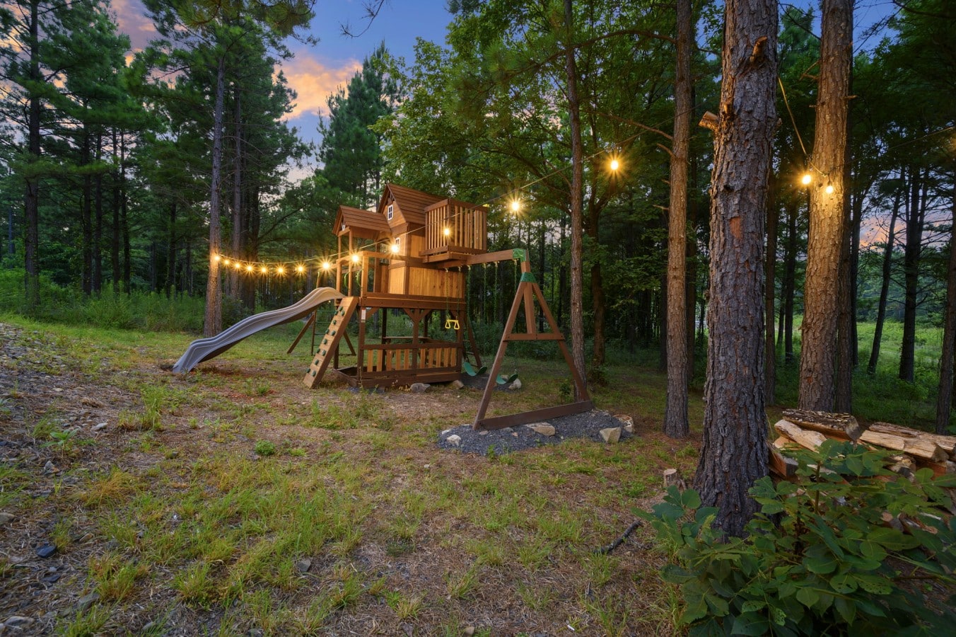 Play area tucked into the trees for kids to explore during the stay.