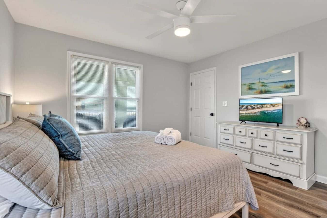This master bedroom is basically the coastal retreat of your dreams—serene, spacious, and with those ocean views and sliding glass doors that make waking up feel like pure luxury.