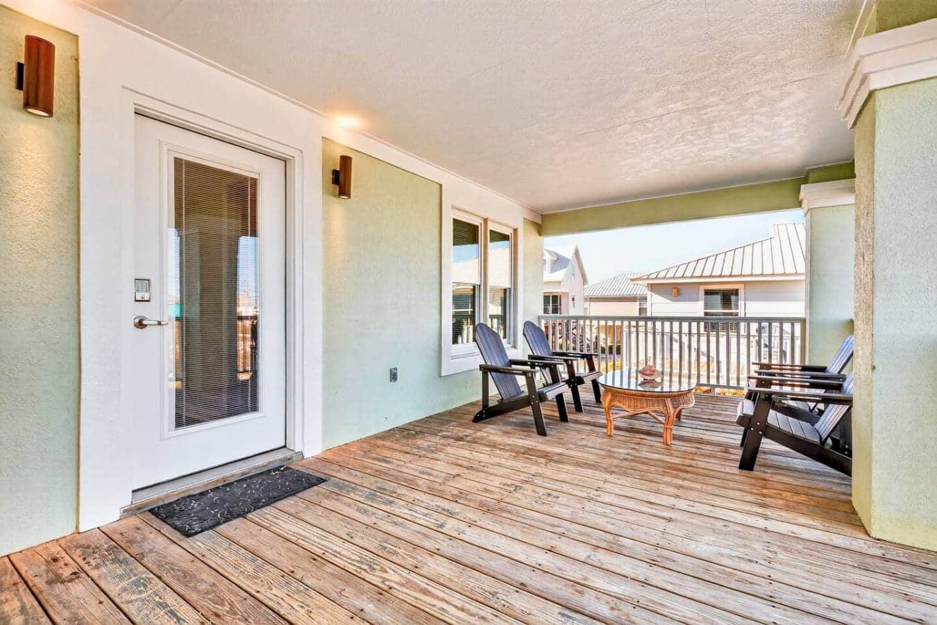 Spend your days lounging on this sprawling covered deck with those perfect Adirondack chairs facing the ocean—it's the kind of spot where time just stops and the view does all the talking.