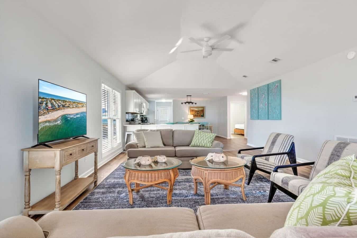 This spacious open-concept living room is basically made for those lazy beach days—tons of natural light, comfy seating for the whole crew, and easy flow straight to the kitchen whenever the mood strikes.