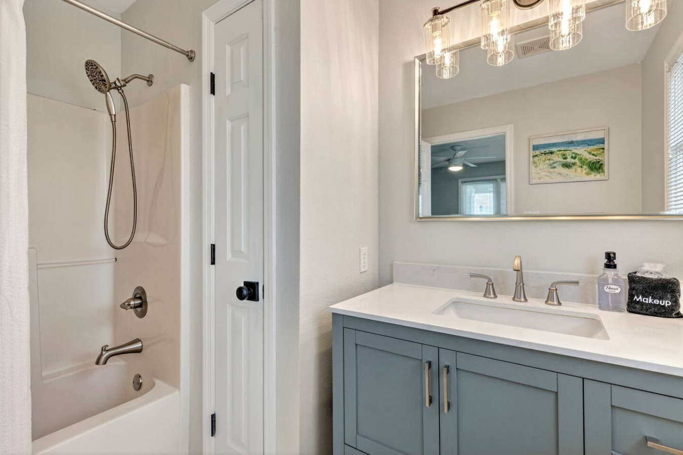 This sparkling master bath with its dual vanities, soft lighting, and serene coastal vibes is basically your personal spa—the perfect spot to wash off the sand and start or end each day feeling refreshed.