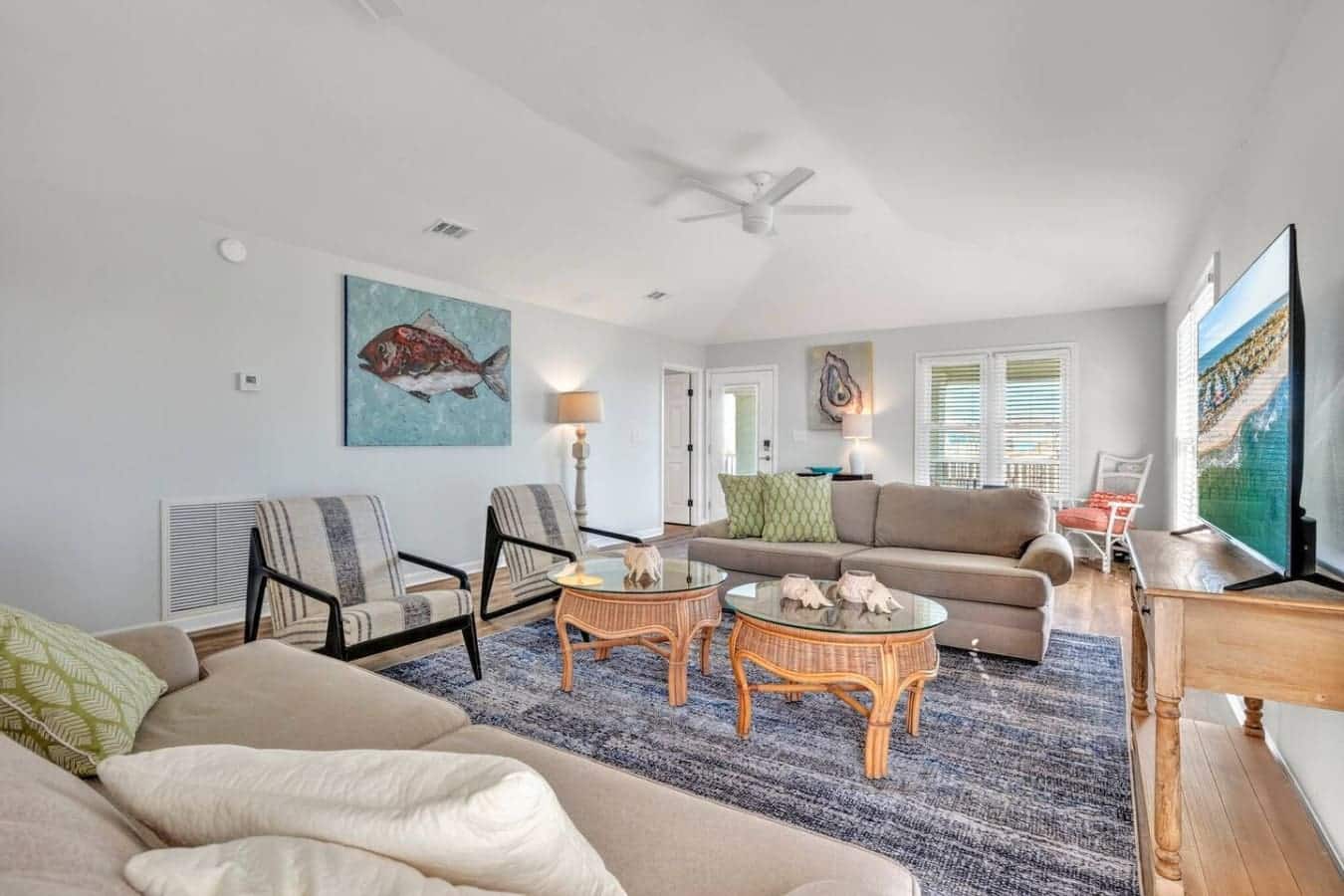 Gather everyone in this spacious, light-filled living room where the open layout and multiple seating areas make it easy to hang out together while still having your own cozy corner to chill out in.