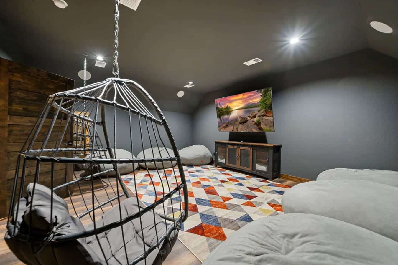 This epic hangout room features a suspended egg chair, multiple beds, and a cozy entertainment setup perfect for groups.