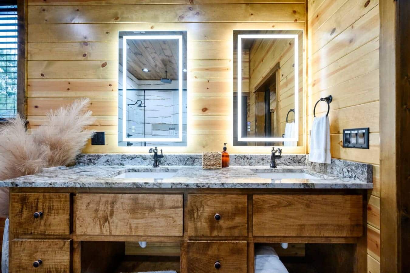 This spa-like master bath features dual vanities with heated mirrors, granite countertops, and gorgeous wood finishes throughout.