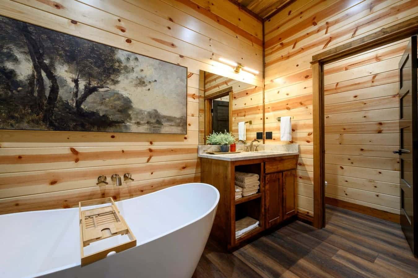 Soaking in this wood-lined bathroom with a freestanding tub feels like a spa day in a cozy cabin.