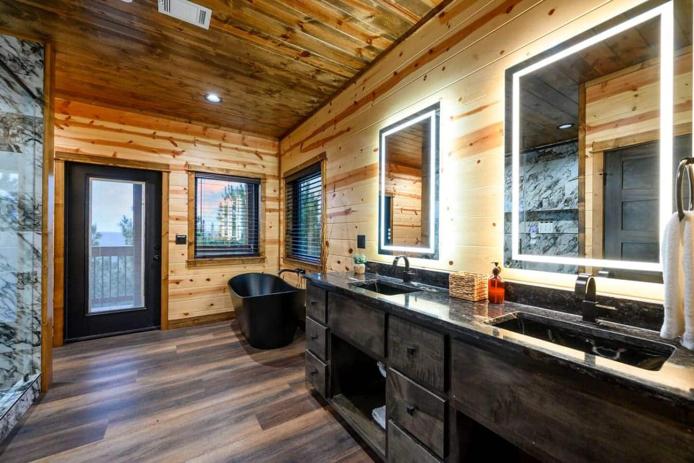 This master bath is absolutely stunning with dual vanities, a soaking tub, and those incredible mountain views from the windows.