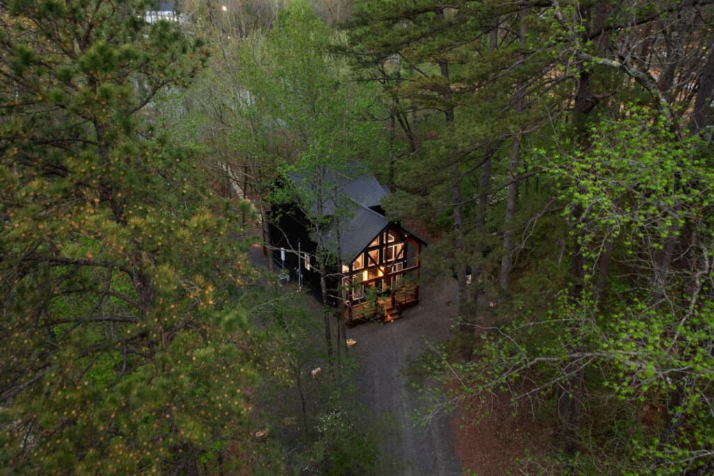 This inviting cabin deck offers peaceful views of the tranquil pond.