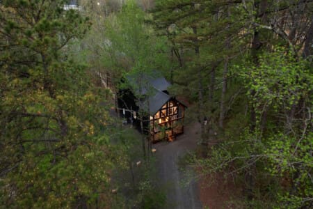 This inviting cabin deck offers peaceful views of the tranquil pond.