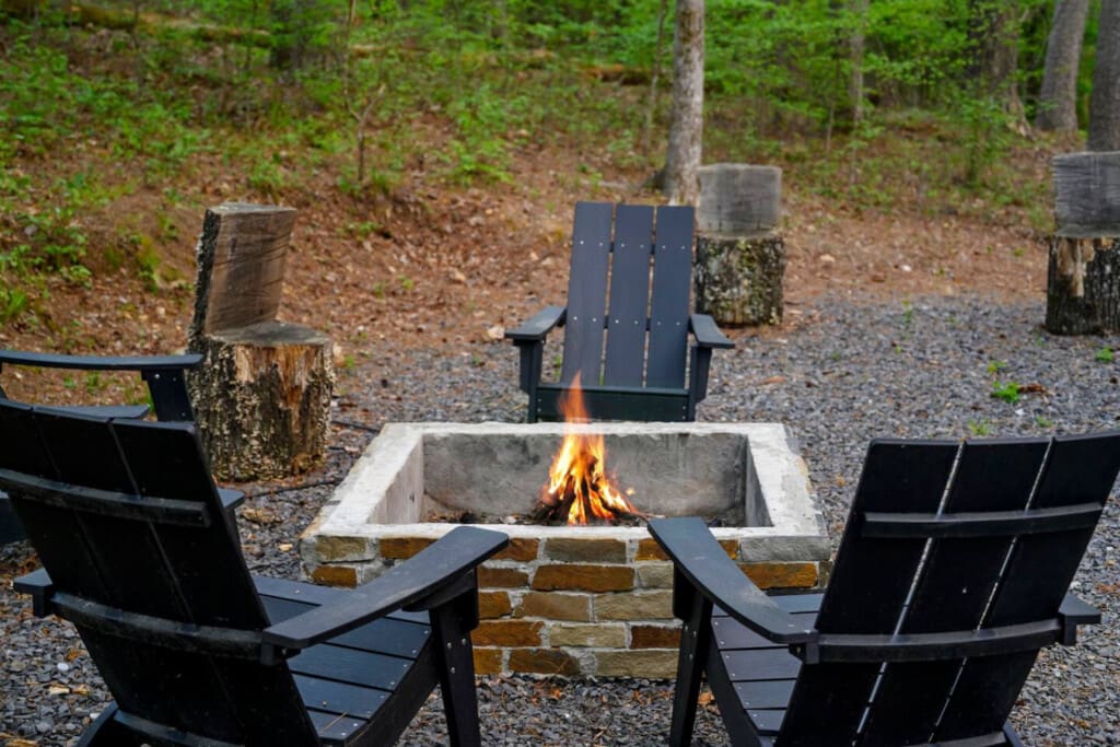This inviting cabin deck offers peaceful views of the tranquil pond.