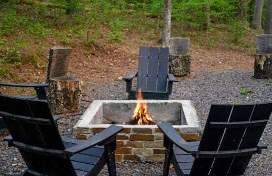 This inviting cabin deck offers peaceful views of the tranquil pond.