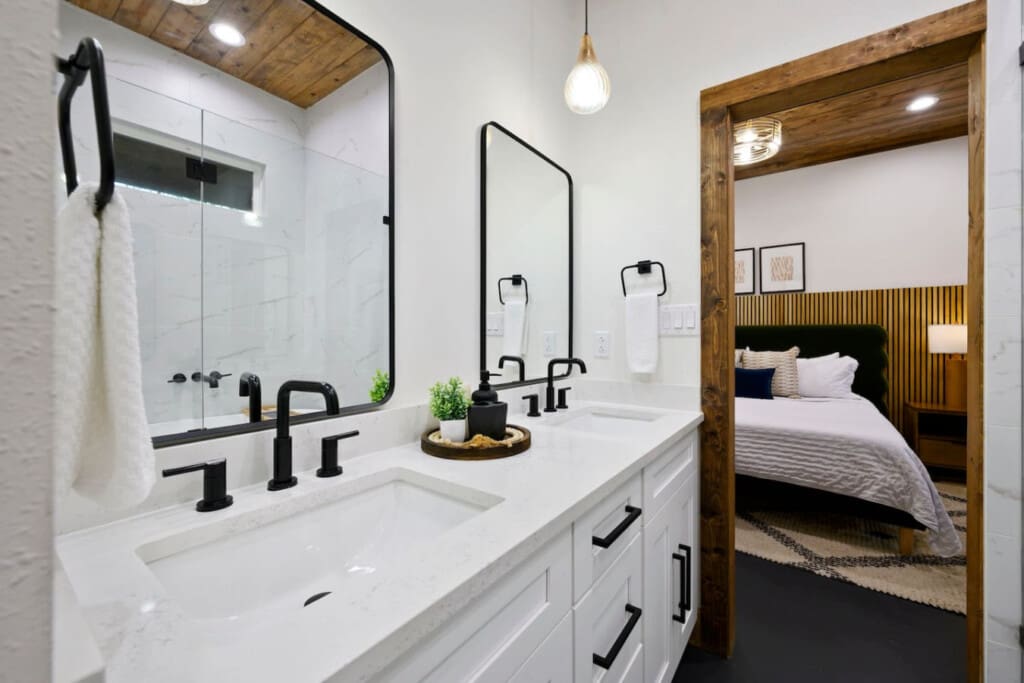 The modern bathroom features a spacious shower and elegant finishes.