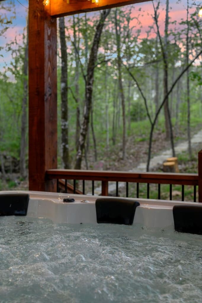 This inviting cabin deck offers peaceful views of the tranquil pond.