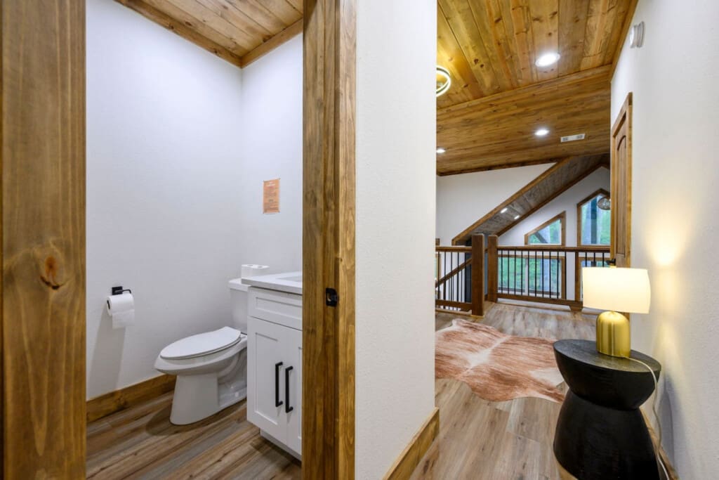 This inviting cabin deck offers peaceful views of the tranquil pond.