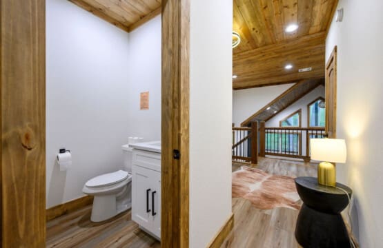 This inviting cabin deck offers peaceful views of the tranquil pond.