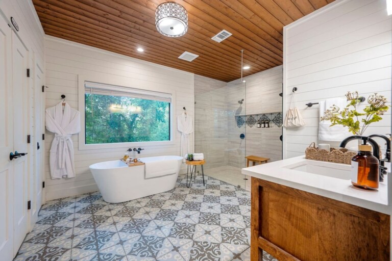 A chandelier-lit soaking tub with a private forest view makes every bath a ritual.