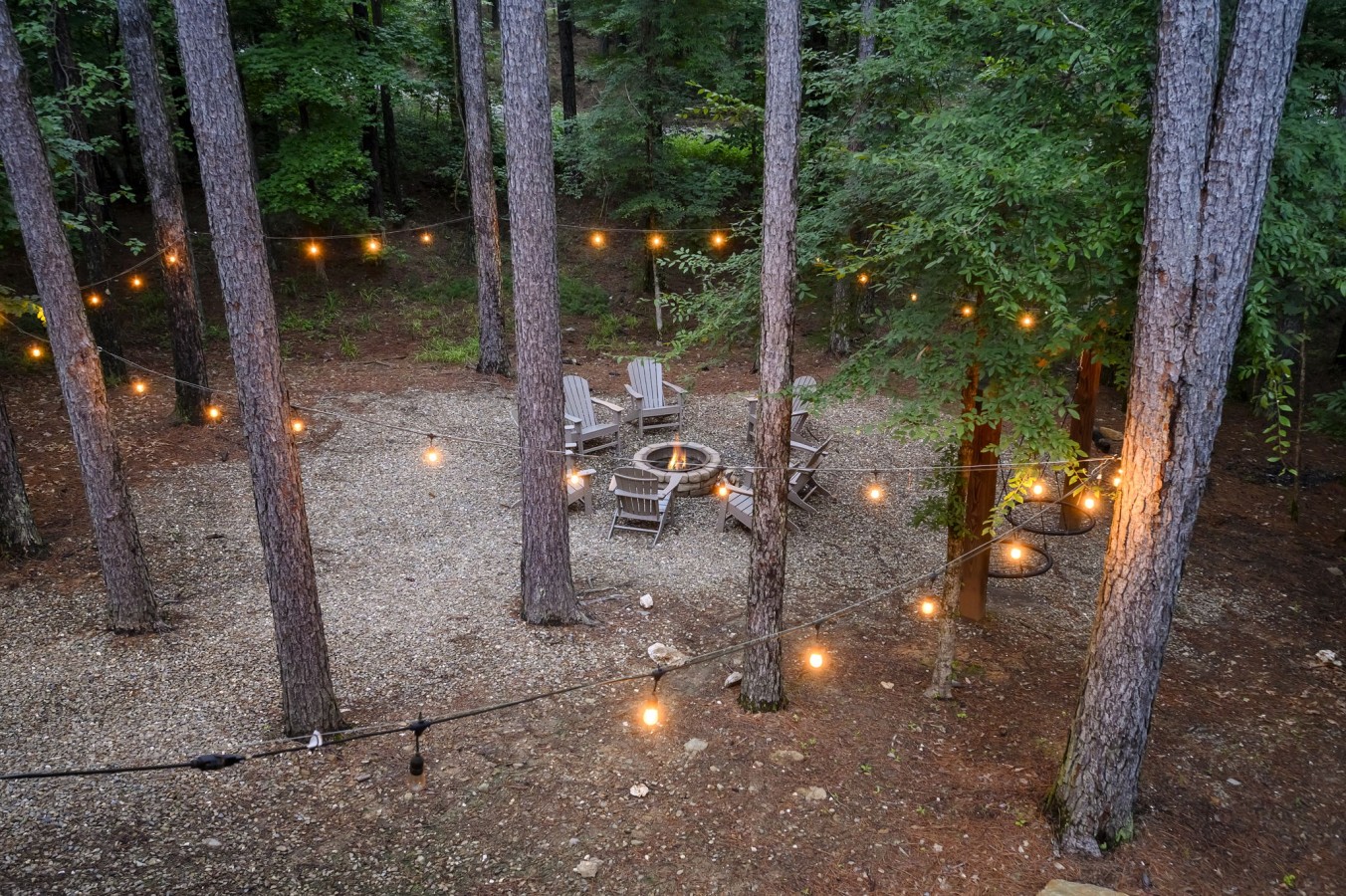 Crisscrossing lights and a glowing fire circle create an atmosphere no bonfire playlist can top.