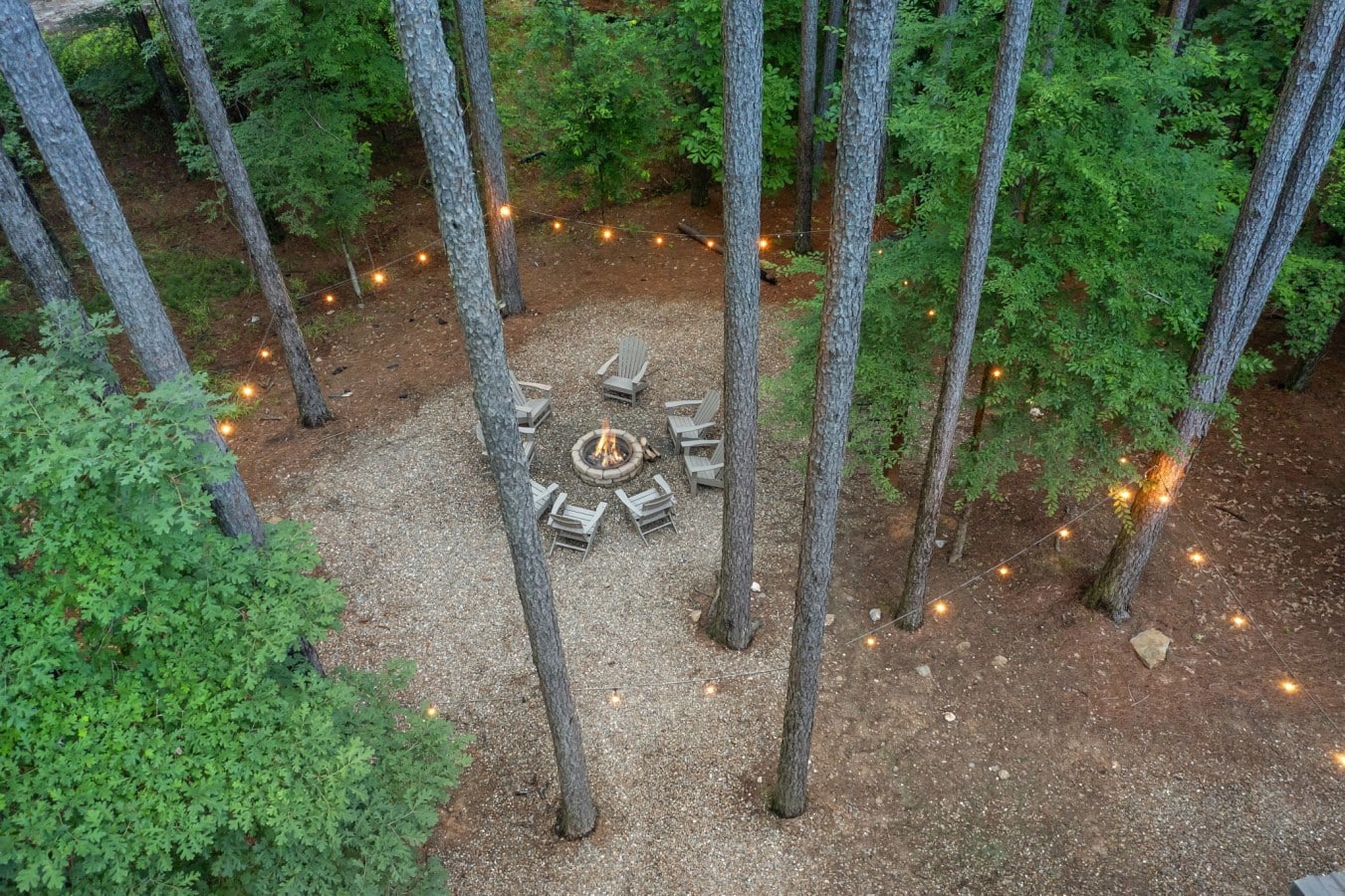 Seen from above, the fire pit circle draped in string lights looks like something out of a dream.