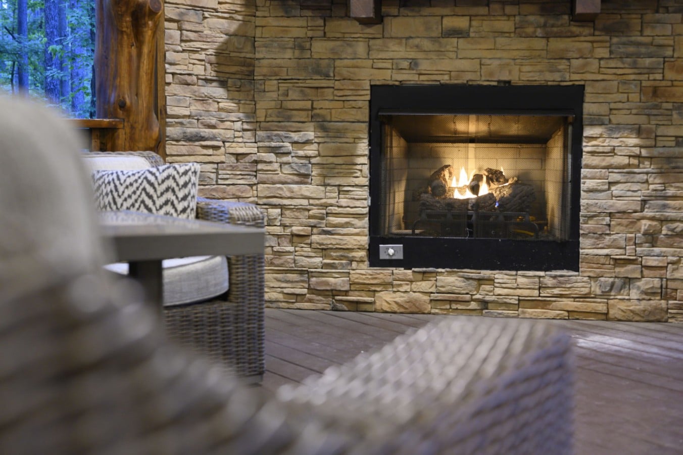 Curl up by the stone outdoor fireplace as the forest glows golden at dusk.